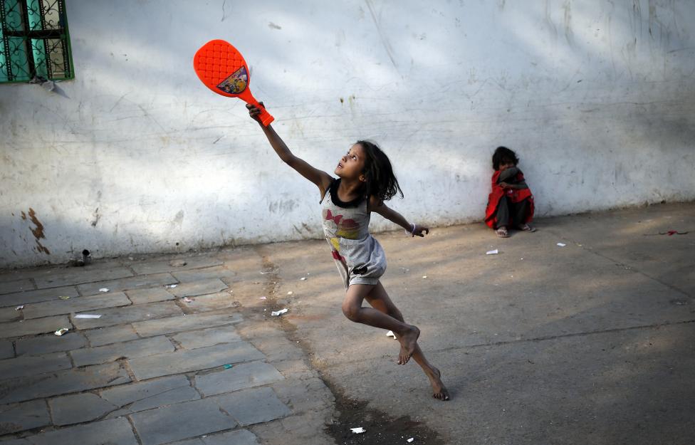 A child plays with a plastic badminton racket in the old quarters of Delhi, March 3, 2016. REUTERS/Anindito Mukherjee