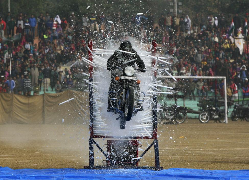 A policeman performs a stunt on his motorcycle during the Republic Day parade in Jammu, January 26 2016. REUTERS/Mukesh Gupta