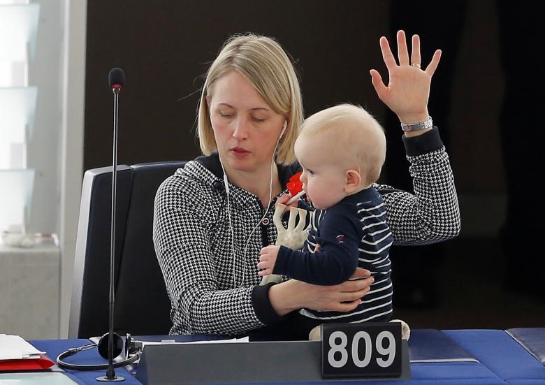 Swedish Member European Parliament Jytte Guteland holds her baby as she takes part in a voting session at the European Parliament in Strasbourg, France. REUTERS/Vincent Kessler